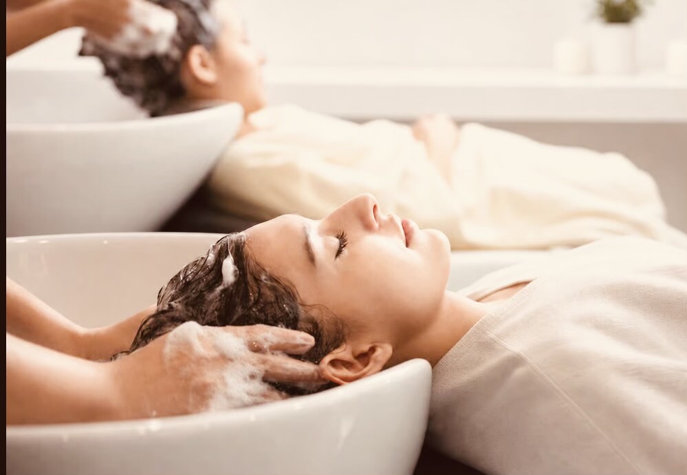 Guest enjoying a head spa ritual at the shampoo basin